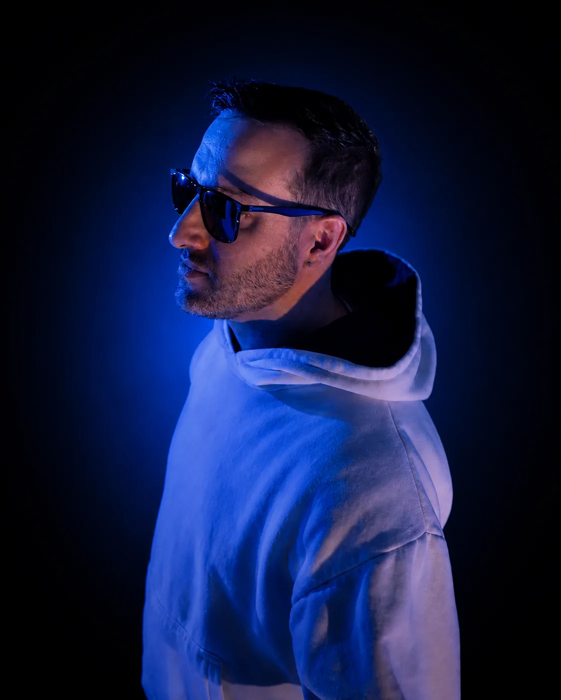 Gonza Sheche con luz azul, de perfil